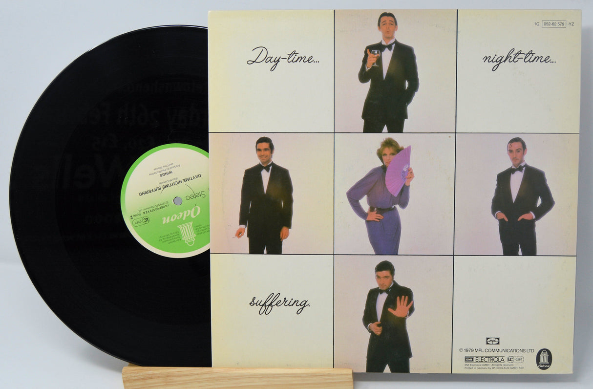 Back cover of Wings' Good Night Tonight vinyl single featuring band members in formal attire and sectioned day-night theme