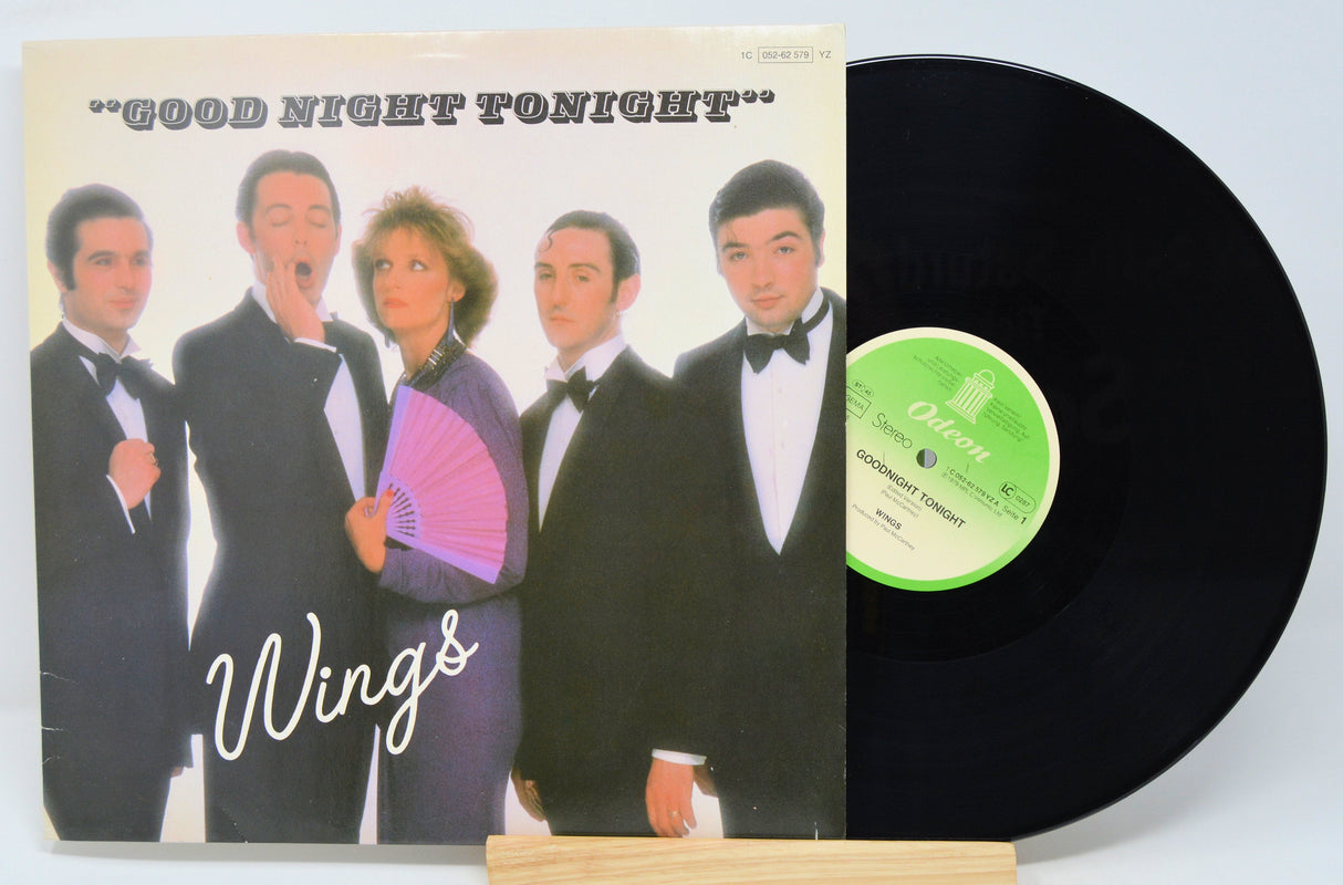 Front cover of Wings' Good Night Tonight vinyl single, showing the band in tuxedos with a purple fan, alongside the vinyl record