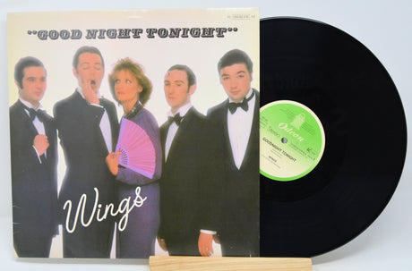 Front cover of Wings' Good Night Tonight vinyl single, showing the band in tuxedos with a purple fan, alongside the vinyl record
