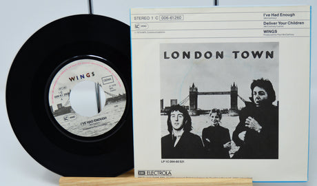 Vinyl record and cover of 'London Town' by Wings on a light blue background