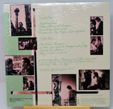Vinyl record sleeve with black and white photos and green text on a light background