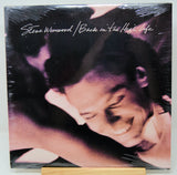 Album cover of 'Back in the High Life' by Steve Winwood featuring a close-up of a person with a blurred background.
