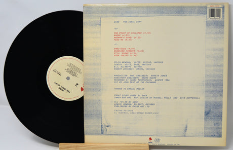 Vinyl record with cover displaying track listings on a light gray background