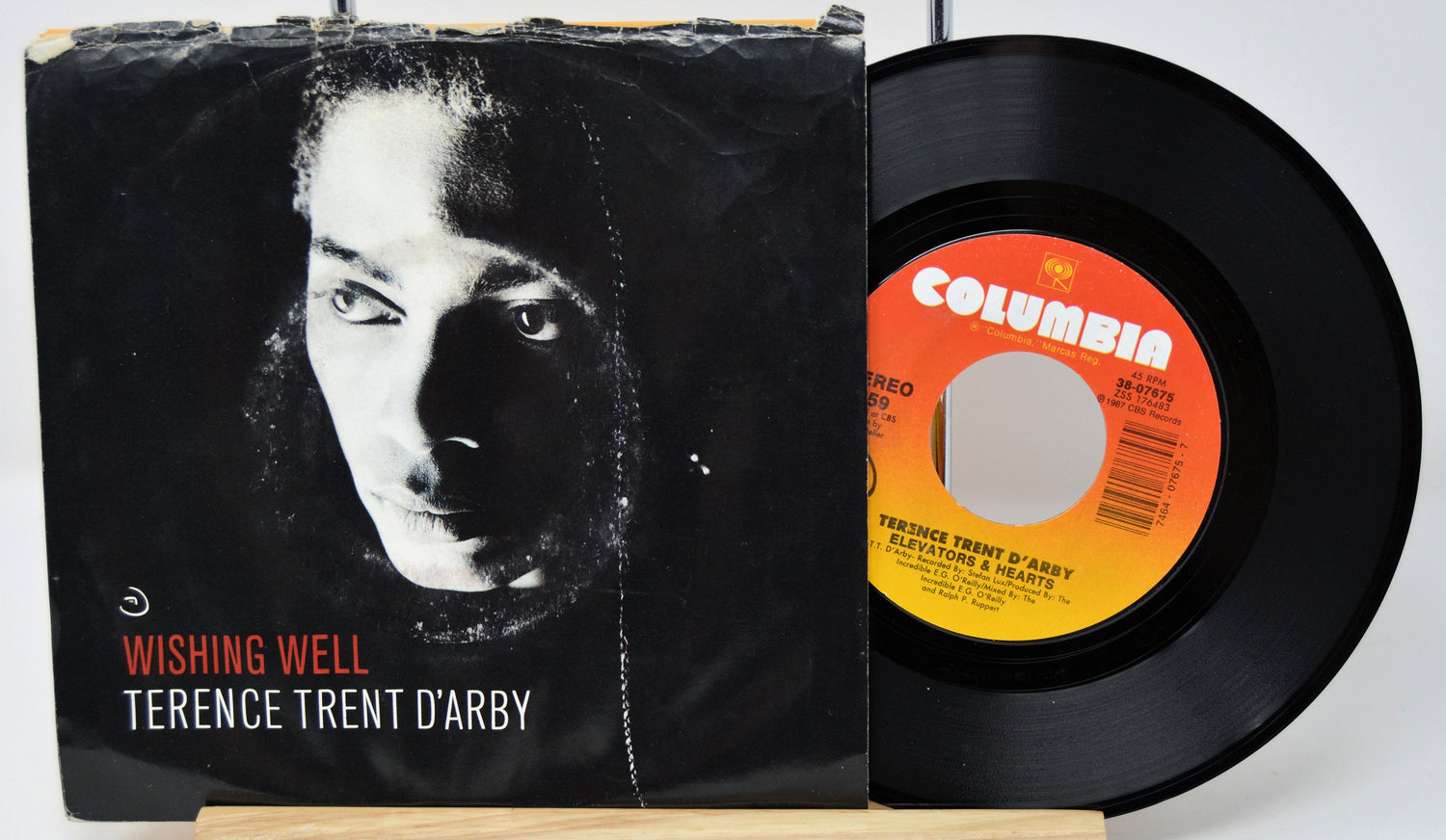 Front cover of Wishing Well 45 RPM vinyl single by Terence Trent D'Arby with record partially showing