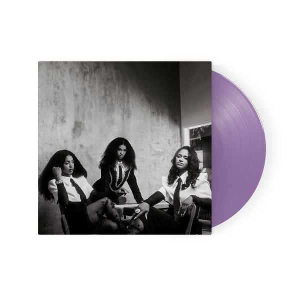 Vinyl record with a purple disc and black and white photo of three people on the cover