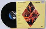 Vinyl record with its cover displaying album artwork and text.