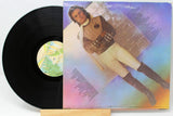 Vinyl record and back cover of Gary Wright's Dream Weaver with a photo of him standing and song listing.