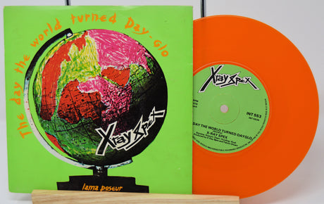 Vinyl record with green cover and orange disc featuring Xayaxax branding.