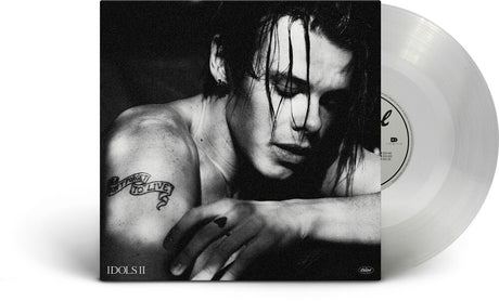 Vinyl record with a black and white cover featuring a person with a tattoo.