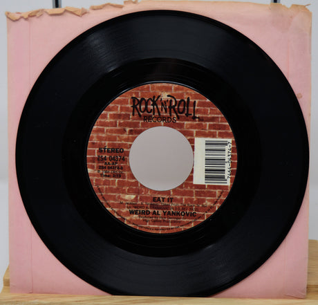 Vinyl record with a brick-patterned label on a pink sleeve