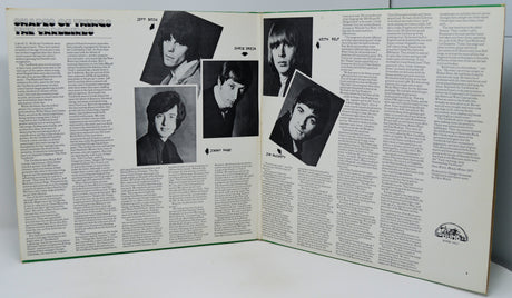 Album liner notes with black and white photos of a band on a white background