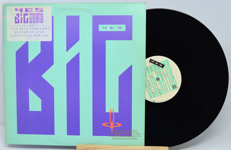 Vinyl record with colorful cover featuring text and abstract designs