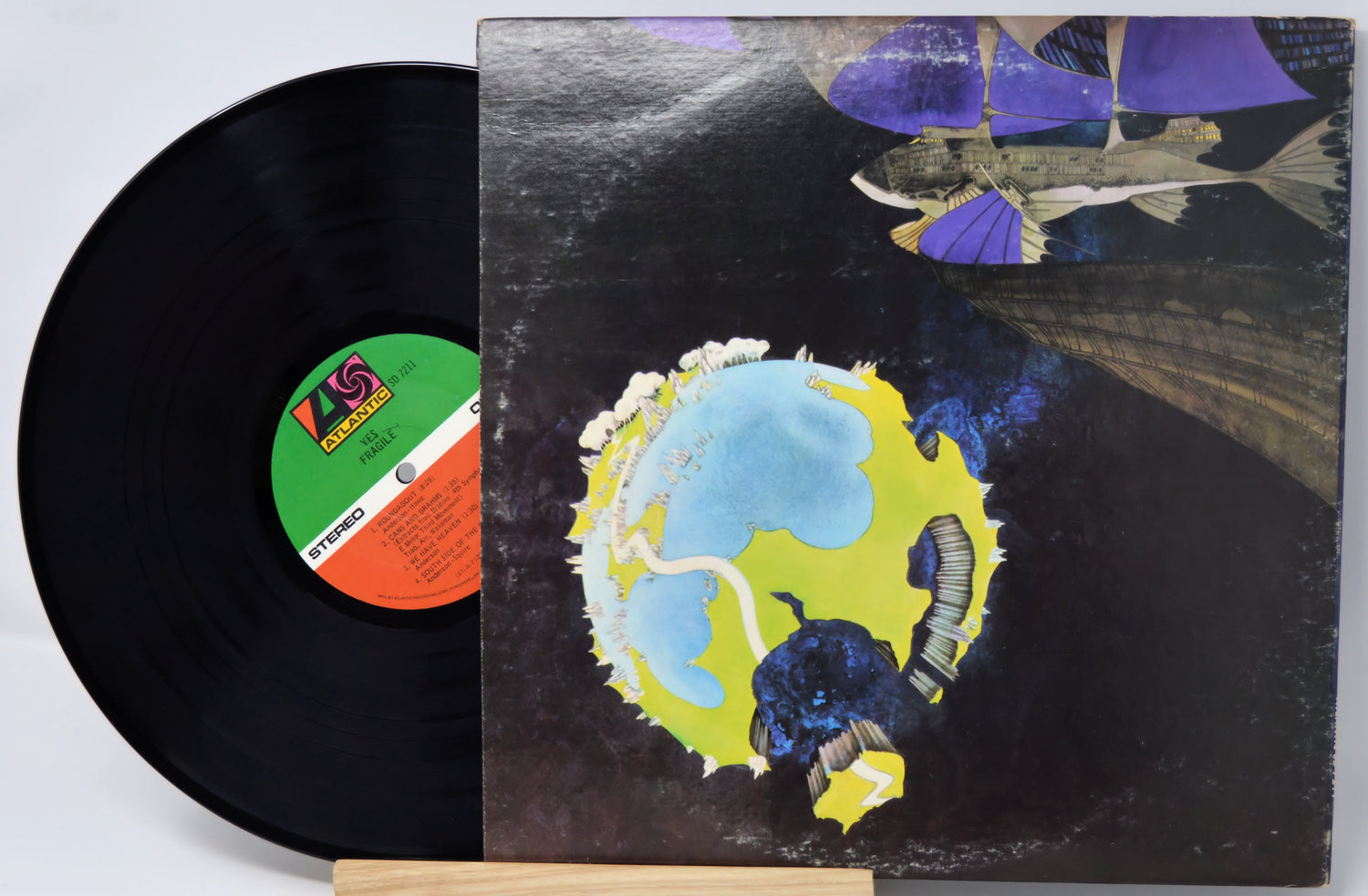 Vinyl record with a colorful album cover featuring a stylized Earth.