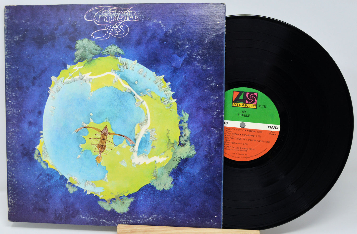 Vinyl record with a colorful album cover featuring a stylized Earth.