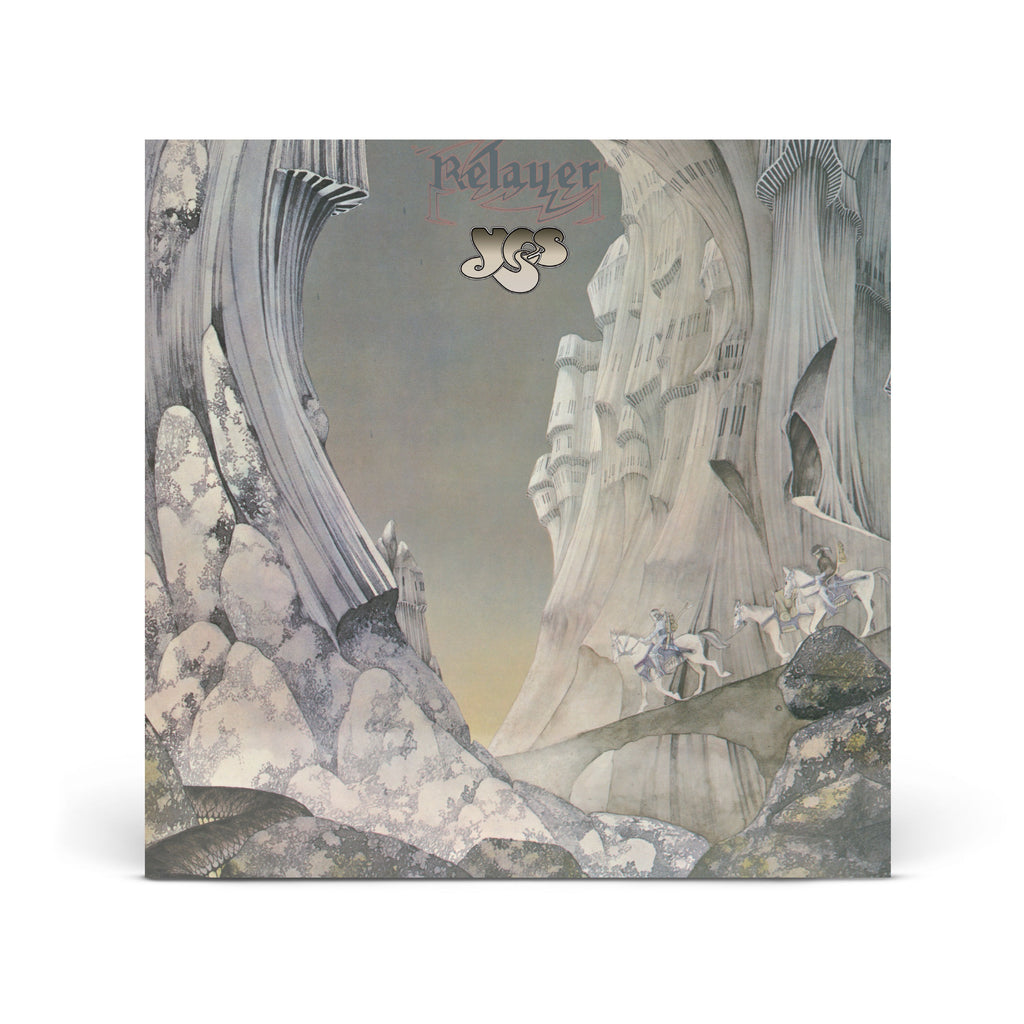 The album cover for Yes's 'Relayer' is shown as a square product shot against a clean white background. The artwork features a surreal, painterly landscape with tall, draped rock formations in muted gray, beige, and off-white tones, with small figures and horses near the lower right.