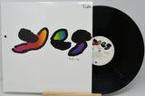 A vinyl record partially pulled from its sleeve, showing the album cover artwork and the black record disc on a light gray background.