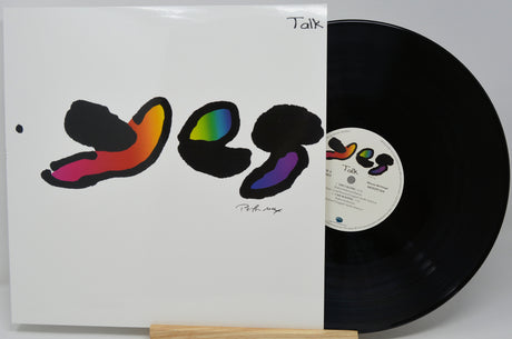 A vinyl record partially pulled from its sleeve, showing the album cover artwork and the black record disc on a light gray background.