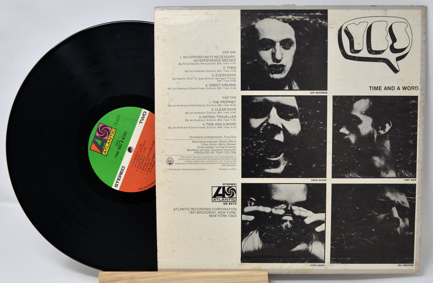 Vinyl record with a white sleeve featuring black and white images and text.