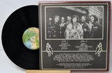 Vinyl record with cover featuring a group of people and track listings.