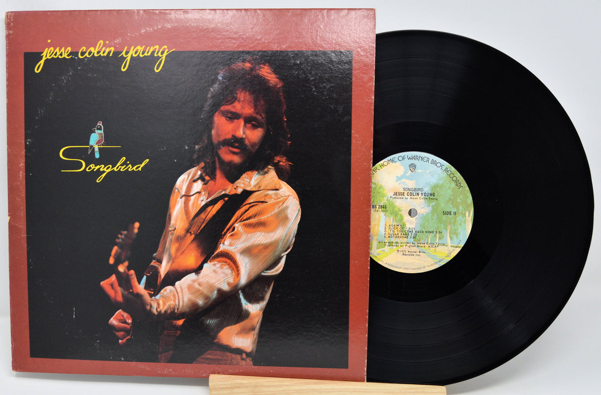 Vinyl record with cover featuring a person and album title 'Songbird' by Jesse Colin Young.