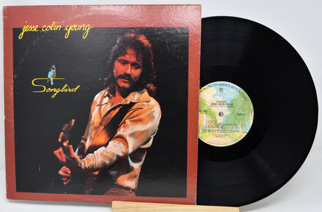Vinyl record with cover featuring a person and album title 'Songbird' by Jesse Colin Young.