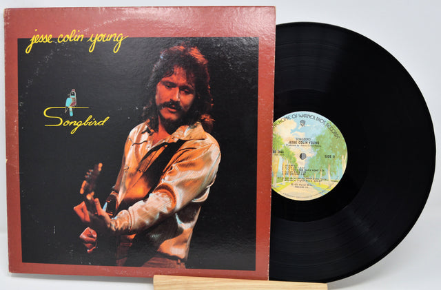 Vinyl record with cover featuring a person and album title 'Songbird' by Jesse Colin Young.