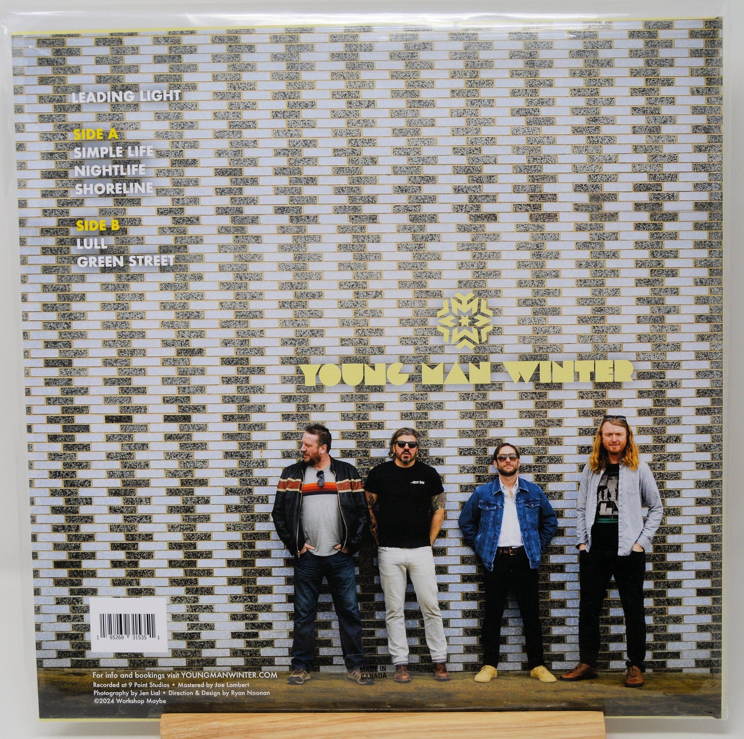 Back cover of Young Man Winter Leading Light vinyl album with band members posed against a brick wall