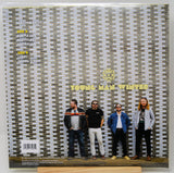 Back cover of Young Man Winter Leading Light vinyl album with band members posed against a brick wall
