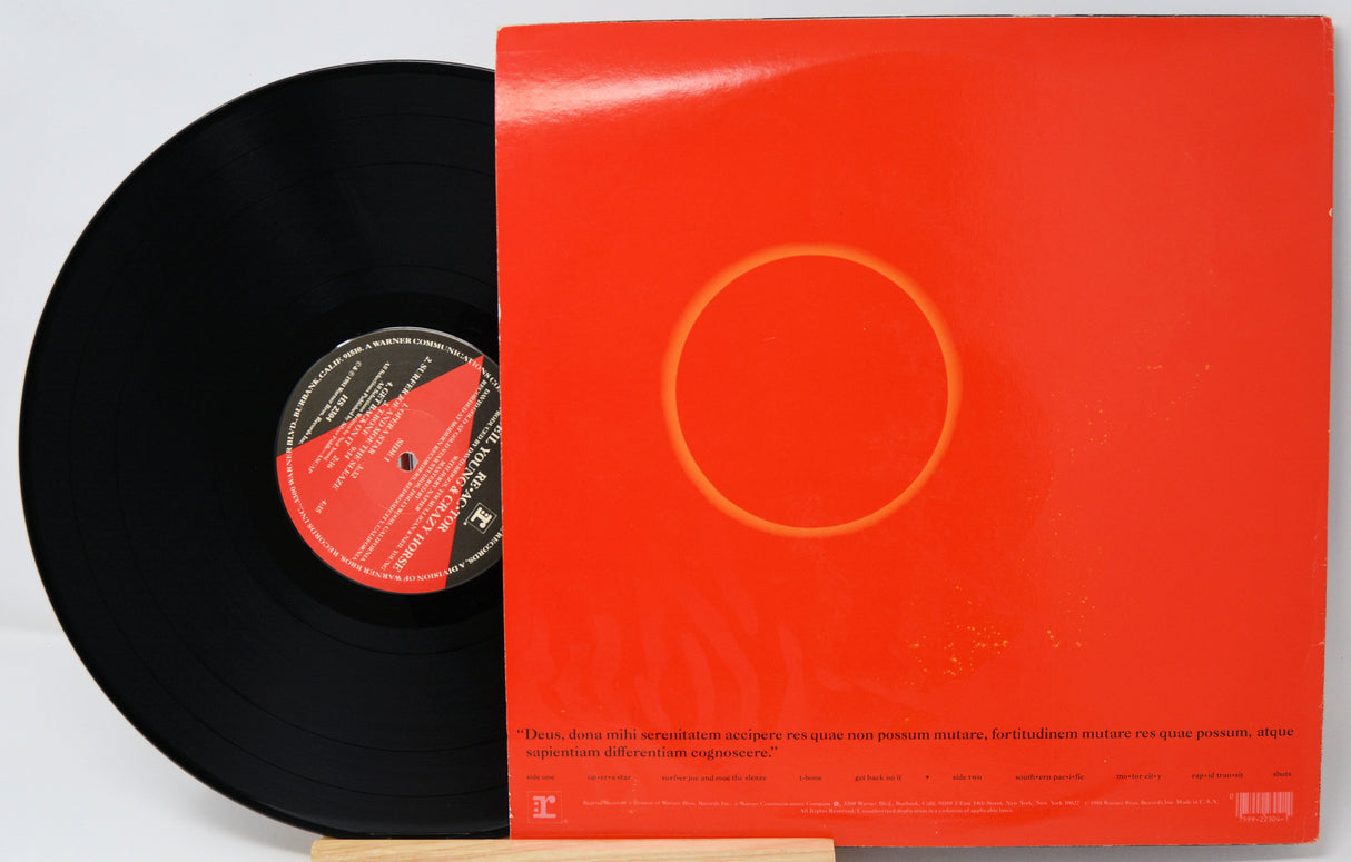 Vinyl record with a red cover featuring a circular design on a white background