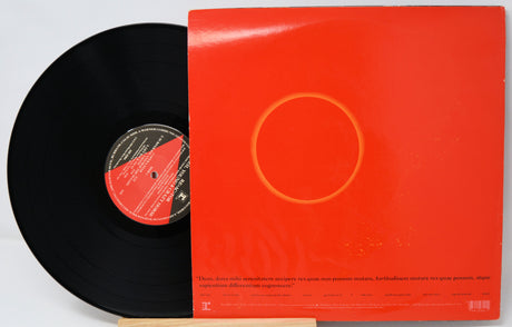 Vinyl record with a red cover featuring a circular design on a white background