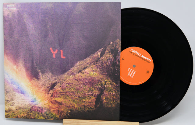 A vinyl record and its album cover for Youth Lagoon's 'The Path of Destruction' are displayed on a small wooden stand against a light gray background.