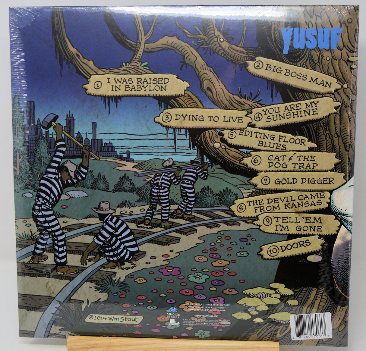 Yusuf's 'I Was Raised in Babylon' vinyl record cover, showing the illustrated back with tracklist labels and a barcode.