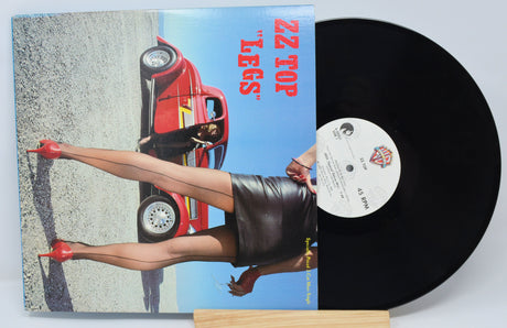 Vinyl record with a colorful cover featuring a car and a person, on a light gray background.