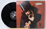 Vinyl record with cover art featuring Frank Zappa in a top hat and mustache.