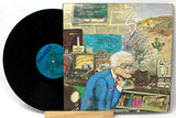 A vinyl record  and rear cover of Frank Zappa's album 'Grand Wazoo' with a colorful, artistic cover featuring a drawing of and older gentleman with a record player, bookcase and plant.