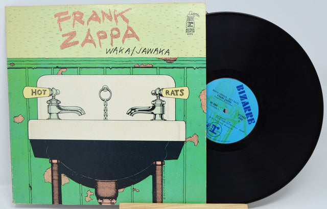 Vinyl record with cover featuring 'Frank Zappa' and 'Waka/Jawaka' on a green background.