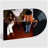Vinyl record with a cover showing two people sitting at a table.