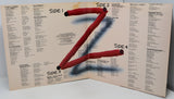 Album cover with a stylized letter 'Z' made of red sticks on a beige background with text.