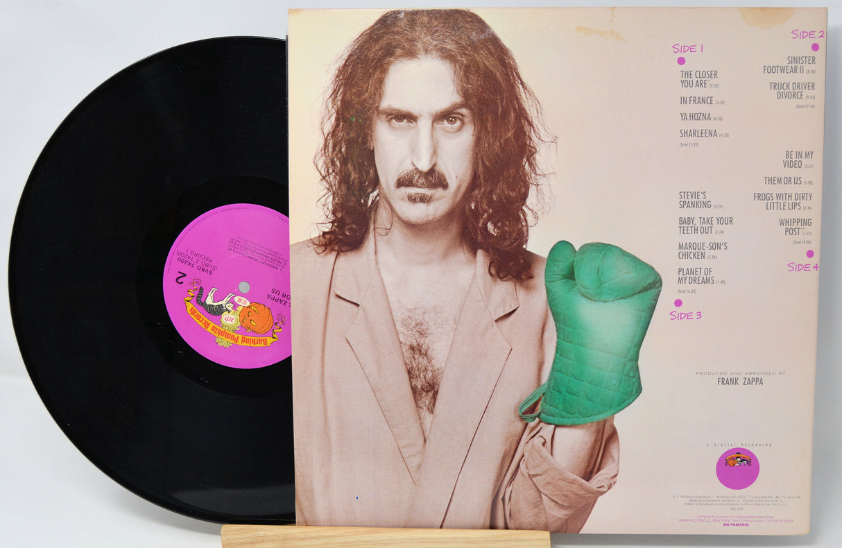 Vinyl record with a person holding a green object on the cover