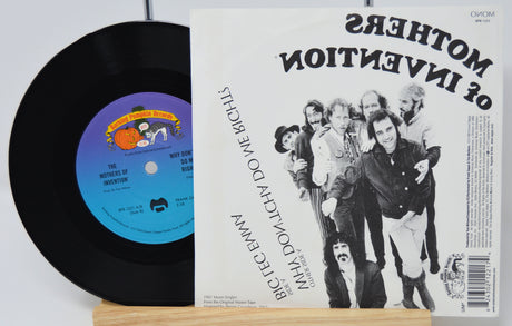 Vinyl record with a colorful label and a music album cover featuring a group of people.