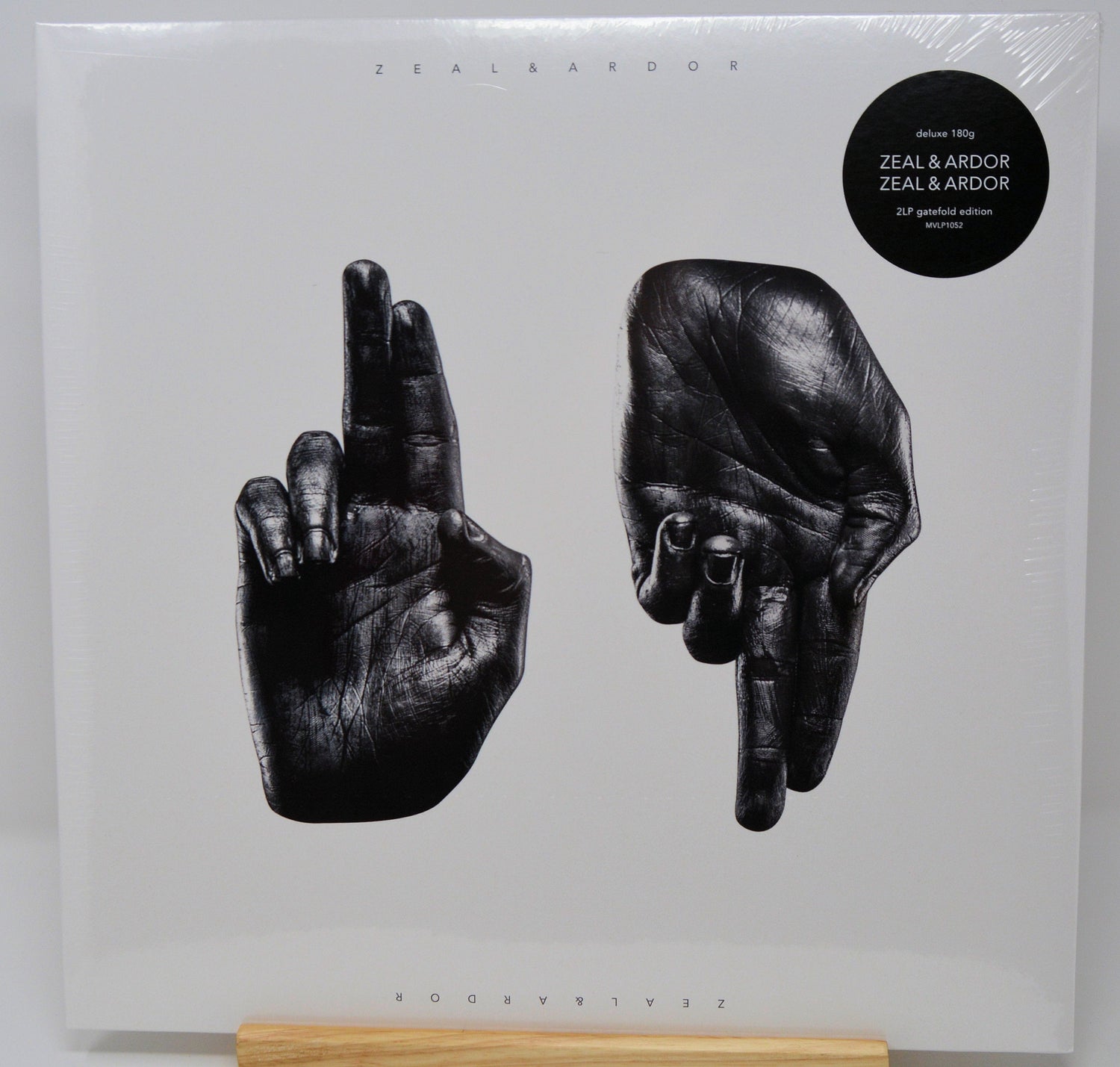 Front cover of Zeal & Ardor deluxe 2LP vinyl with artwork of two black hands on white background