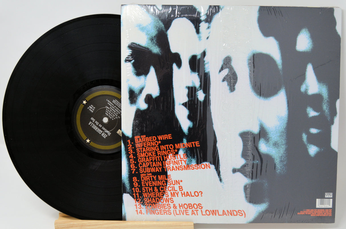 Vinyl record with a black cover and white and gray abstract design on the back