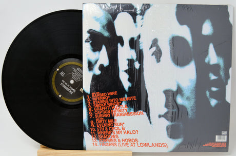 Vinyl record with a black cover and white and gray abstract design on the back