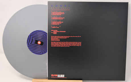 Silver vinyl record by Zombi called 'Shape Shift' and back cover with red text on a black background. 
