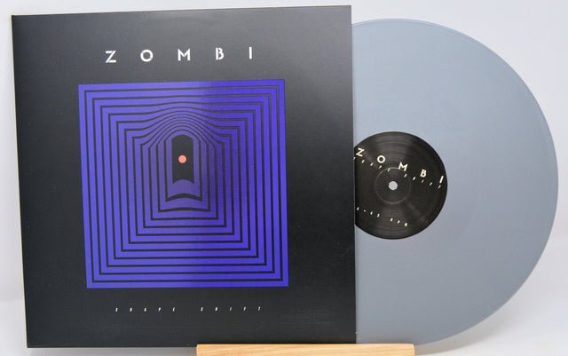 Silver vinyl record called 'Shape Shift' and front cover with blue abstract art on a black background. 