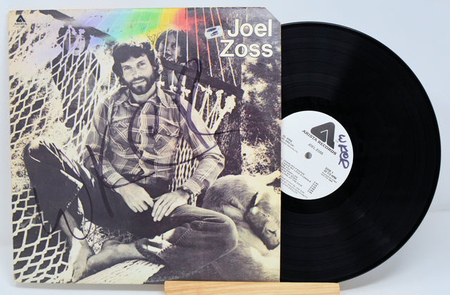 A vinyl record with a label featuring a photograph of Joel Zoss, the artist's name, and the title 'A-103'.