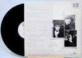 Vinyl record with a white cover featuring black and white photos of a person.