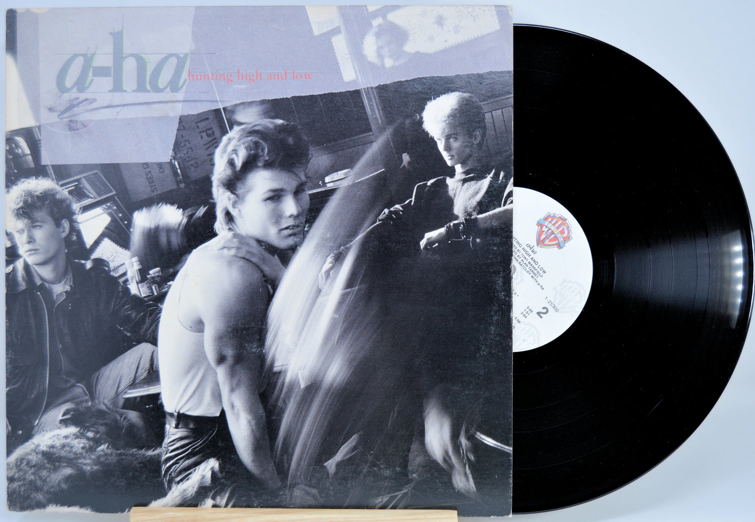 Vinyl record with a cover featuring a group of people and the text 'a-ha'.