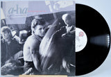 Vinyl record with a cover featuring a group of people and the text 'a-ha'.