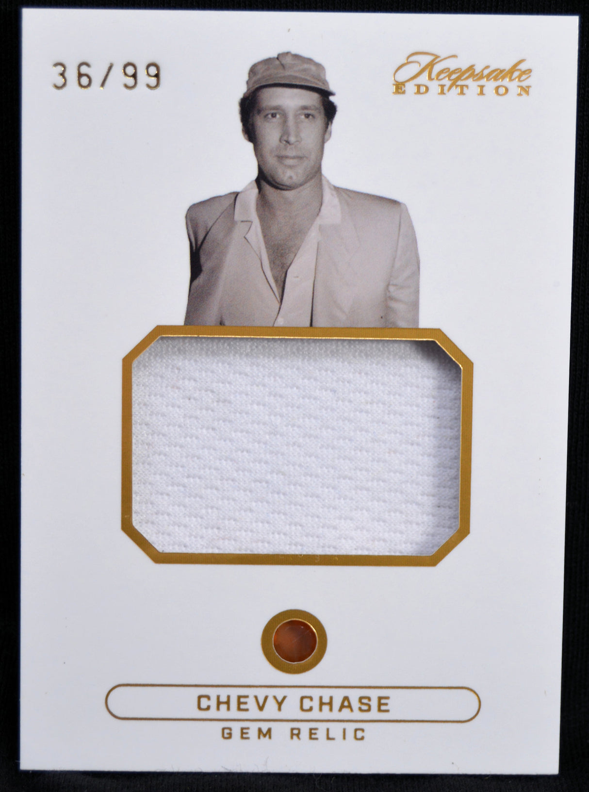 Trading card featuring a photo of a person with a piece of fabric and 'Chevy Chase' text on a white background.